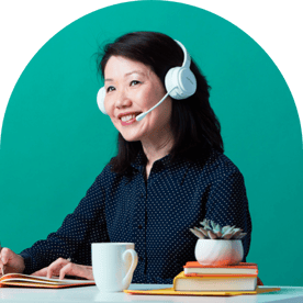 Person at a keyboard with a headset smiling