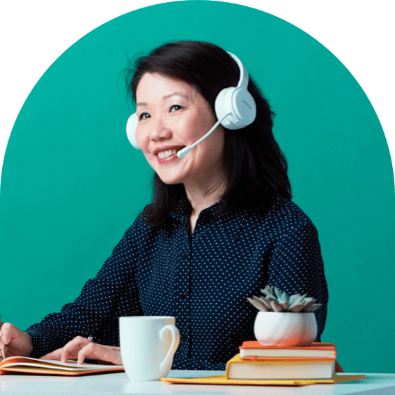 Person at a keyboard with a headset smiling