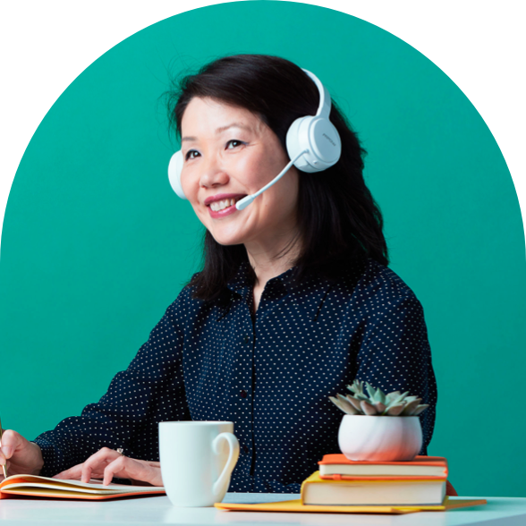 Person at a keyboard with a headset smiling