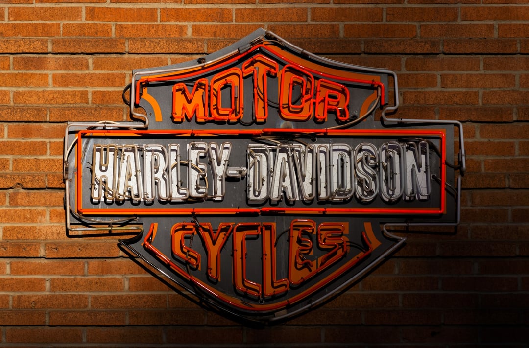 harley davidson motorcycles neon sign in front of a brick wall